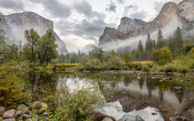 A dramatic scene in the Yosemite Valley as rain showers leave fog